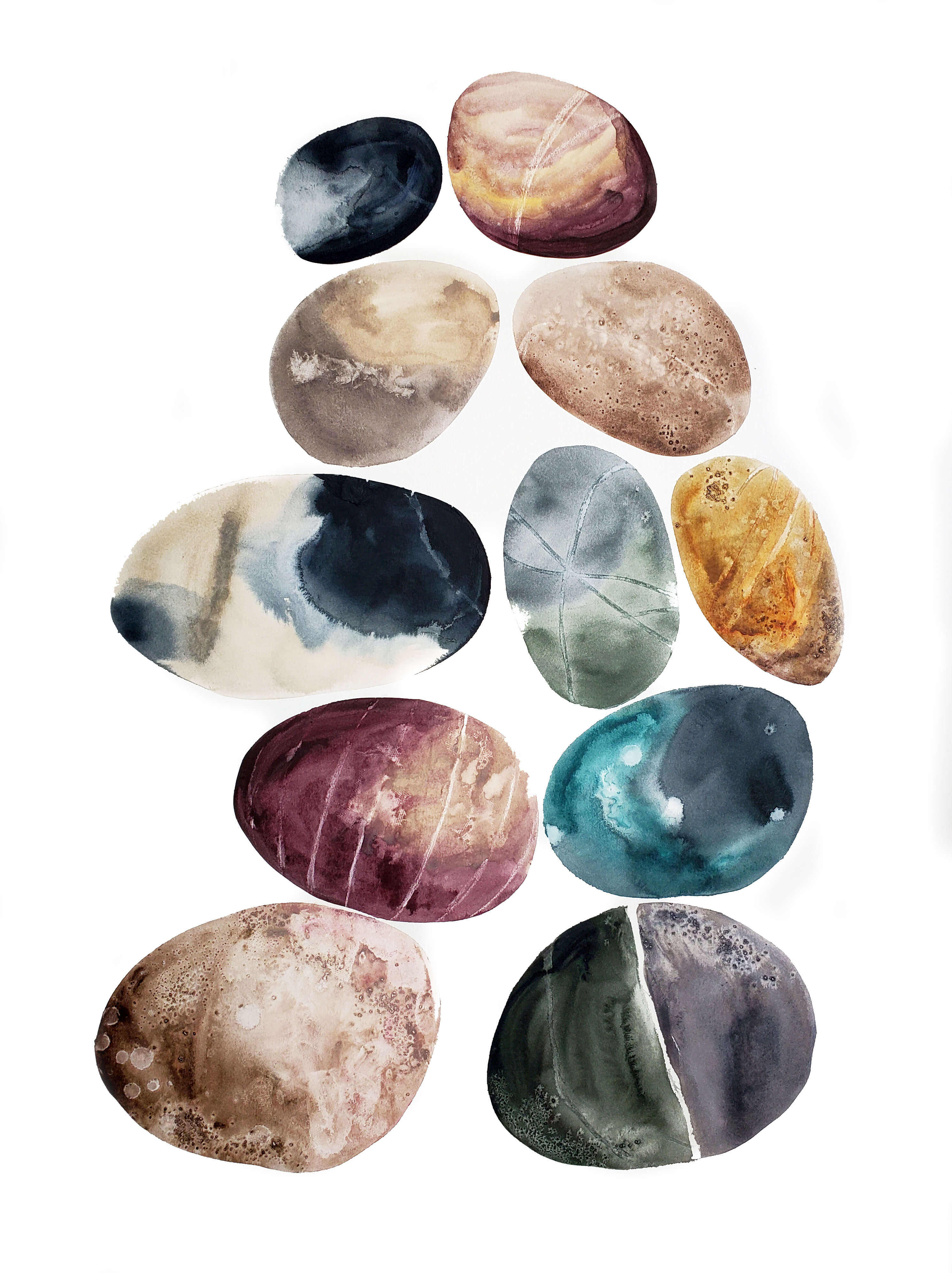 egg shaped stones painted on a white background